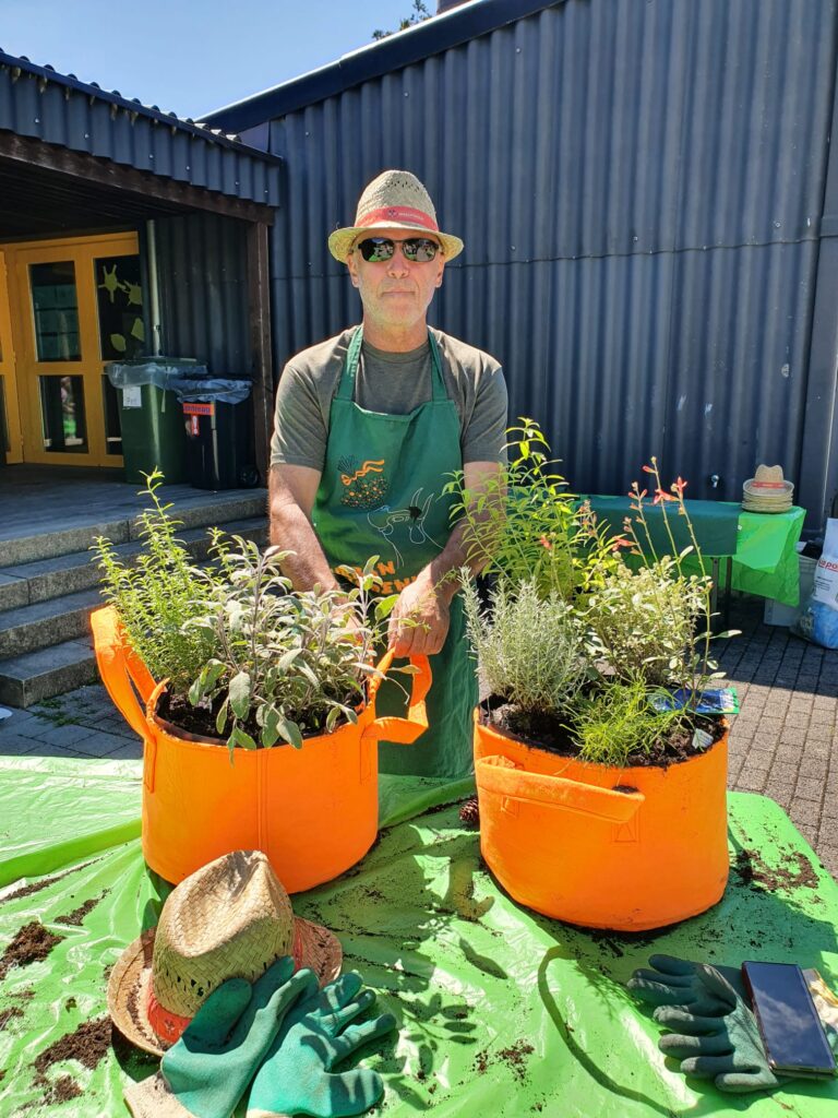 Mitarbeiter beim Kräuter pflanzen am Sommer-Teamevent 2022